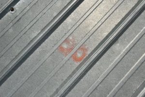 hail damage on metal roof on a roof in northern Indiana